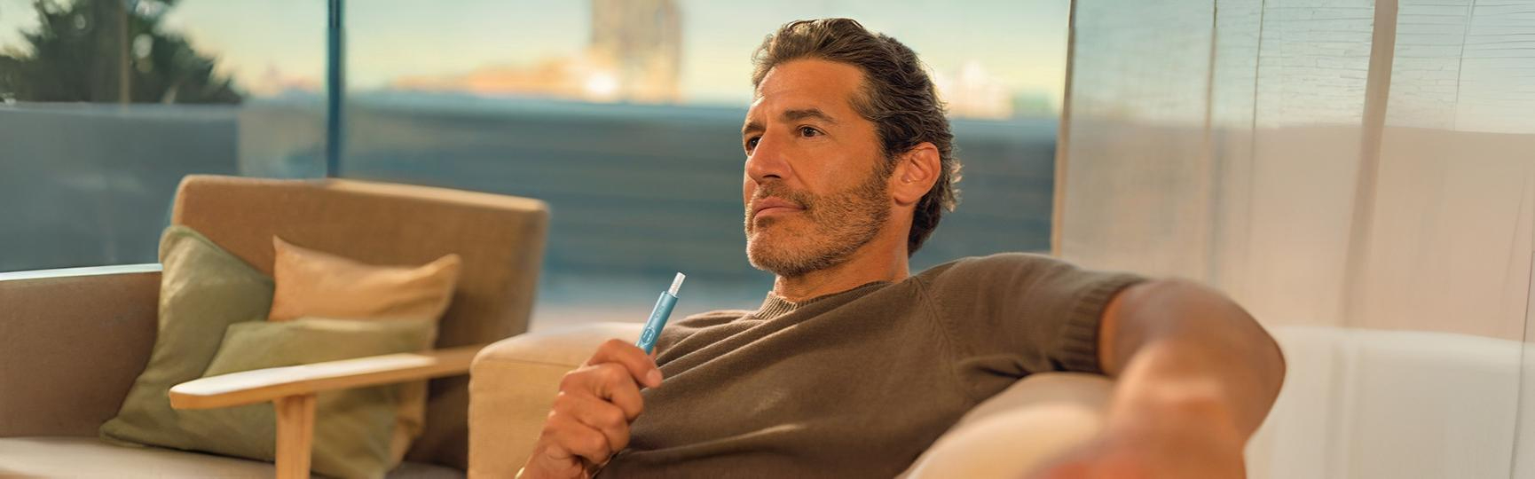 Young man opens his IQOS gift box